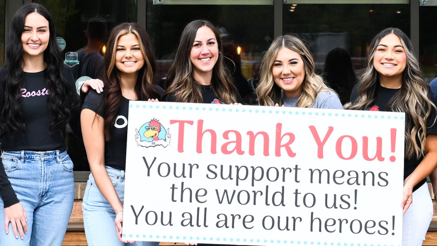 Roosters Employees holding up thank you sign