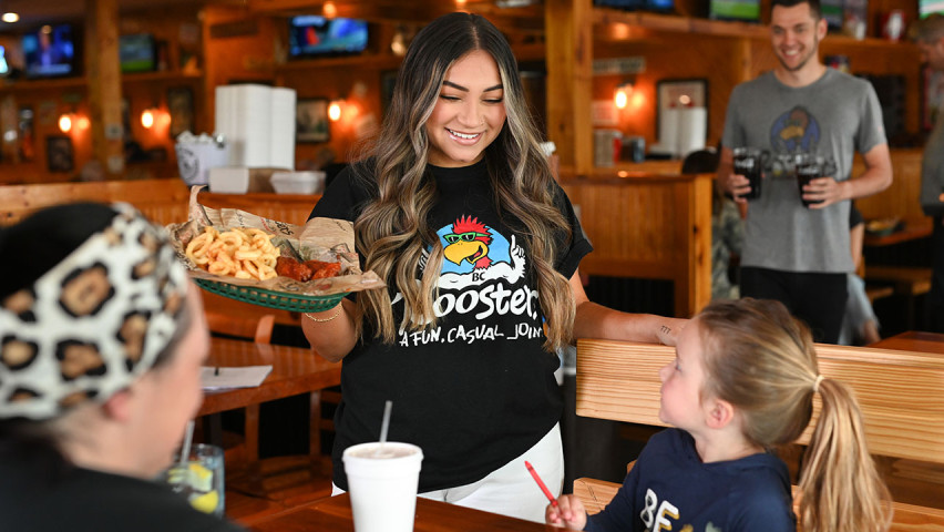 Waitress Serving Food to Customers