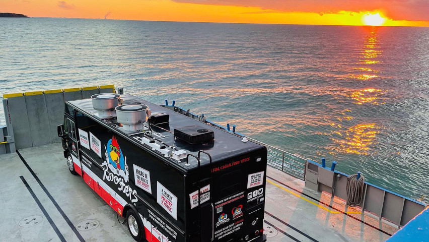 Roosters truck with sunset in background