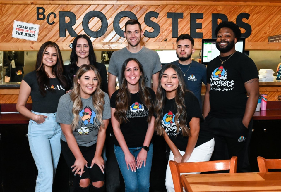 Roosters Employees in front of Roosters food truck